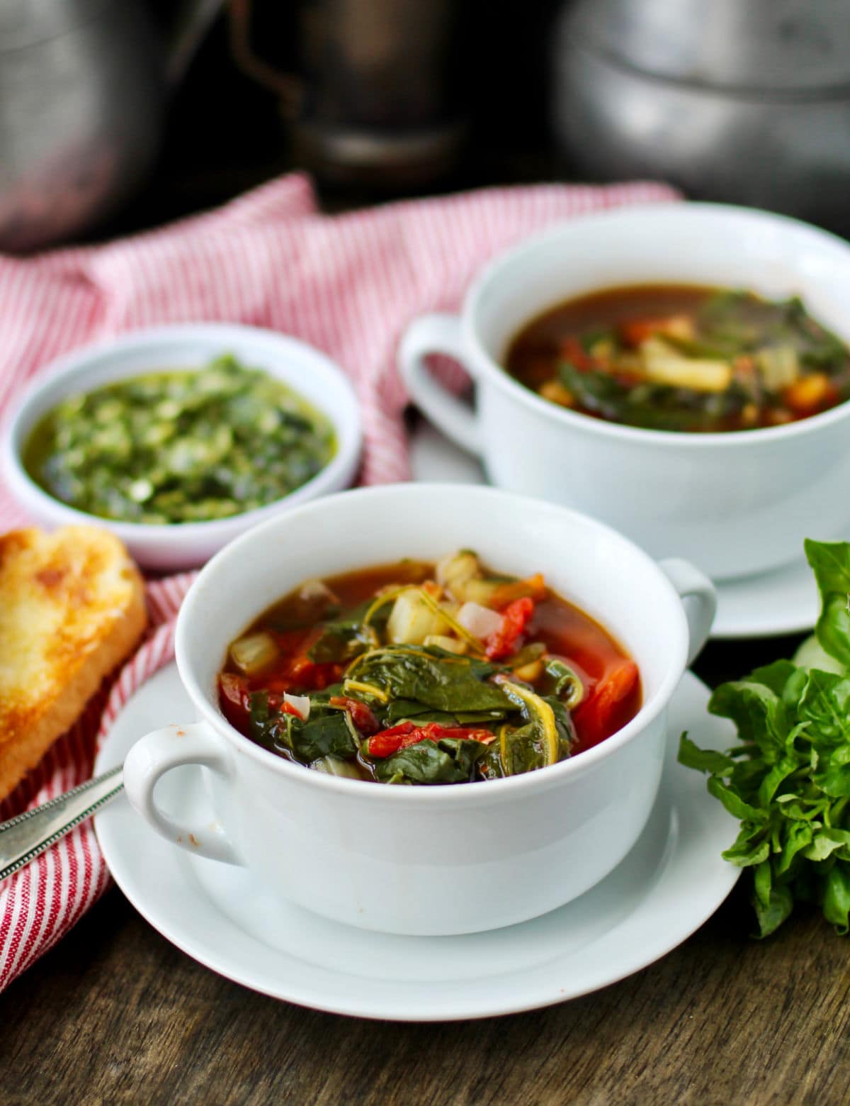Swiss Chard and White Bean Soup with Basil Pesto in a bowl.