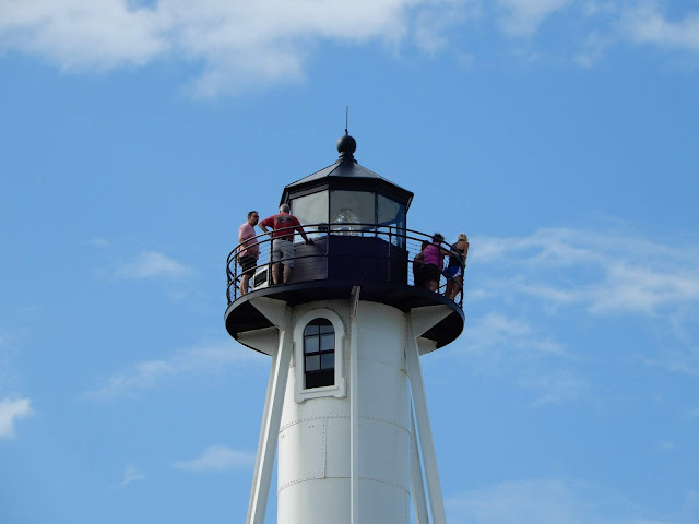 people at the top of the lighthouse