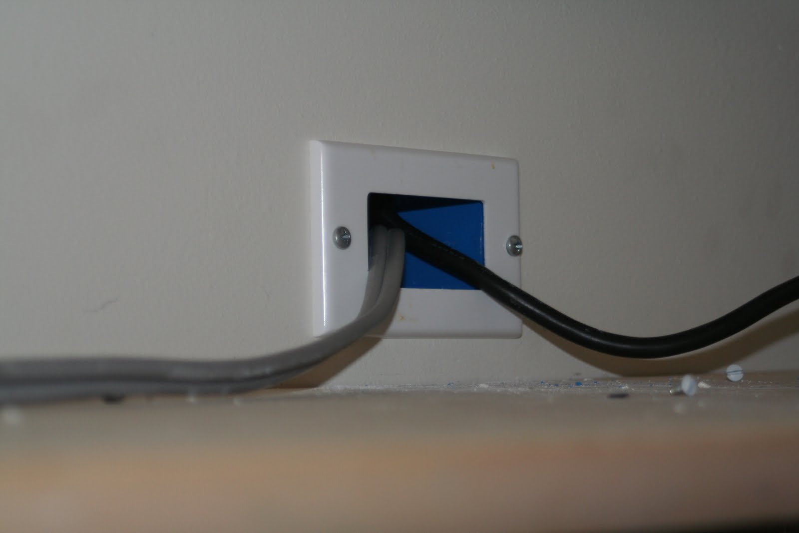 The TV mount and cable source at the bottom.