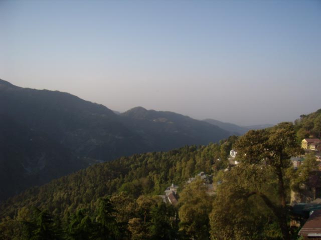 Beautiful Trek towards snow covered peaks of Dainkund from Dalhousie (Casual Clicks without editing) : Posted by VJ Sharma at www.travellingcamera.com : Due to busy schedule these days I am not able to find time to explore places.. Its been two months I am only doing my work :-) So here are few old photographs of a Trek to Dainkund form Dalhousie....Its you have seen my last post about Kala Top Trek, there is a station on main road called Lakkar Mandi from where we change the route towards Kala Top... For Dainkund also, we take right cut from Lakkar Mandi...Dainkund gets maximum snowfall in Dalhousie region...There is a road till the top of this hill, but we chose to trek this distance with some drinks and snacks ... (I don't want to be specific here...)This whole stretch is full of natural richness... Deodars all around and clouds moving here and there to save from hash sunlight on the hills...A view of Khajjiar Lake from Dainkund... Wind on these high hills is chilly and fast.. I completely different experience... We spent some time sitting on these hills and when we moved in calm places(dense deodar forests, there was a continuous beep sound in our ears....We didn't follow this road because it becomes time expensive and a bit boring.... We used to take short-cuts through various forests on the way... Had chance to play with snow balls also :-)Whole stretch is clean, green and full of colorful flowers... I was not very fond of photography during this time and that is the main reason I am not able to portray real image of this place... It was difficult for me to find photographs without people faces :-)Some criss-cross roads on the way... There are few villages around this trek having beautiful mud houses and bunch of sheep spread over various hills...Initially I was not comformtable with the idea of posting this photograph on my blog.. I searched in google and found that many sites already has this information available... I am not sure if its right or wrong but somehow I feel guilty about the act of taking this photograph :-(I know these photographs are not appreciating the real beauty of the place but believe me it was very exciting trek for us... and I these pictures are not giving real view of the place... This place was probably 10 times beautiful than you see here..There is a series of mountains on the trek and finally we reached a temple on the top... Temple was covered with snow, so we were not able to have darshan there...Some random shots in deodar forests....Darkness inside these forests in clear sunny day...Colorful forests make this trek wonderful... A view to Dalhouise on back journey.. Everyone is waiting to have rest for next day Trip to Chamba....