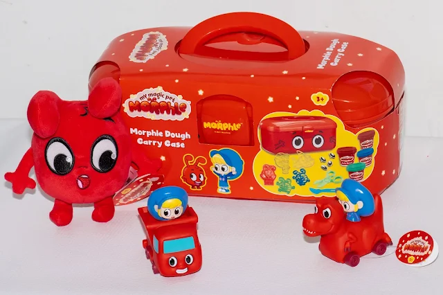 Morphle toys which are all red. There is a red case a red plush and 2 red small vehicles with the girl Mila in