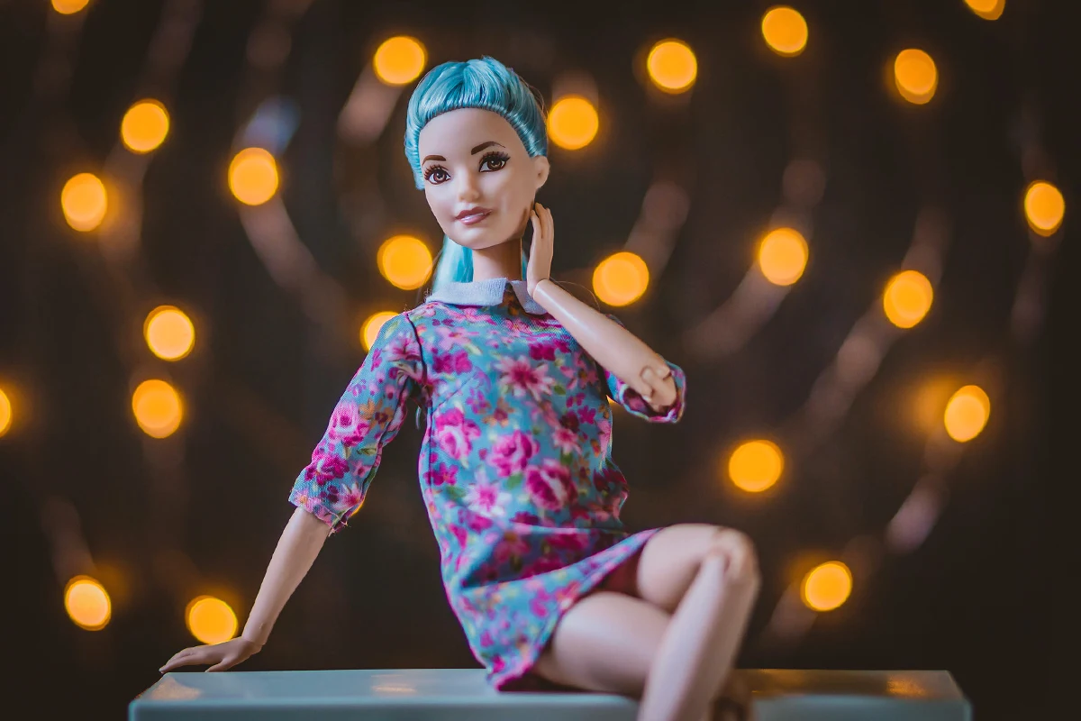 cute barbie doll with blue hair is posing for the camera