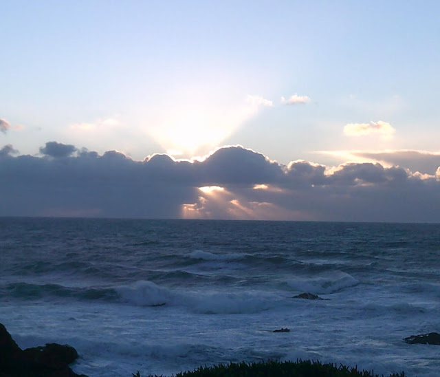 Sunset over the ocean on a cloudy day