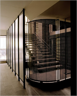 The main staircase sheathed in a series of screens