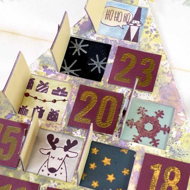 Scrapbook.com stamps, gold metallic ink, frost ink, daffodil hybrid ink; Ranger Archival Ink jet black, thistle; Nuvo Vintage Drops postbox red; Tim Holtz Distress Oxide Ink, Distress Crayons; Ranger gold embossing powder; Prima watercolor pad