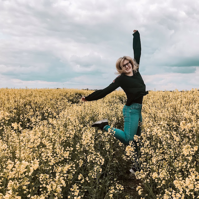 Glitter is the new black motivated jump in a rapeseed field