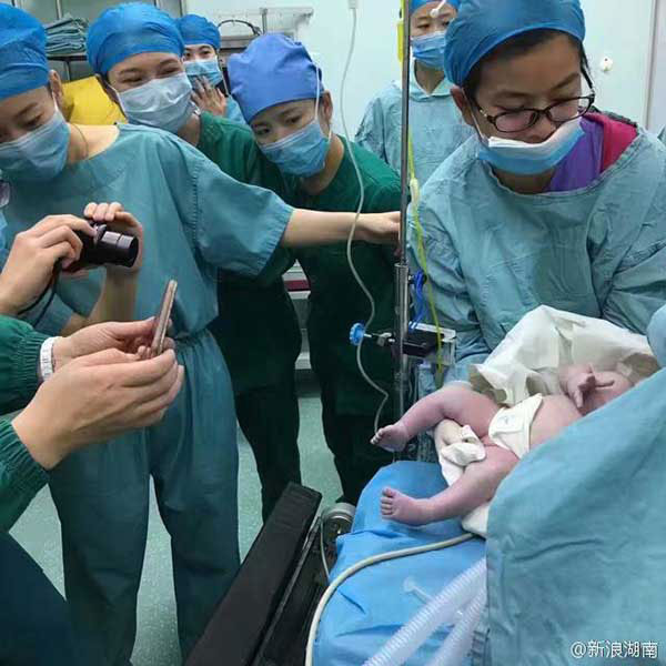 Staff Taking Pictures of the Baby