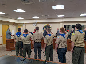 Boy scouts from Troop 126 lead the overflow crowd at the Town Council meeting in the "Pledge of Allegiance"