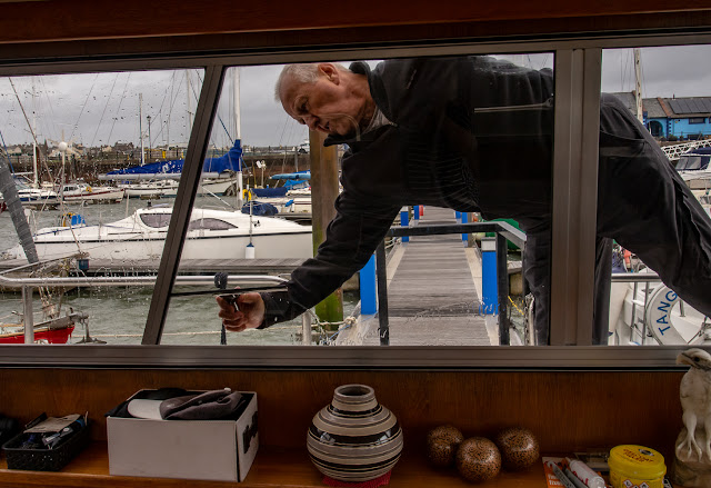 Photo of Phil cleaning Ravensdale's windows during Storm Ali