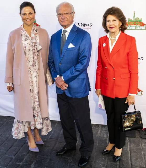 Crown Princess Victoria wore a rose Odnala wool coat by Andiata. By Malina Adele dress. Queen Silvia wore a red blazer