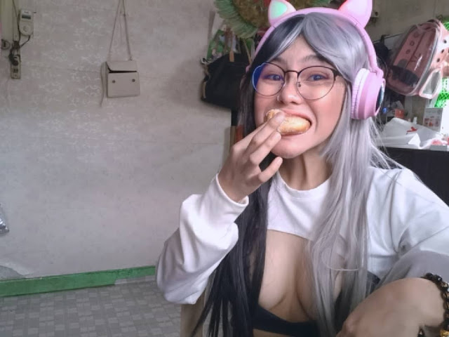 emo filipina woman eating donut