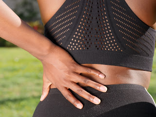 A woman with back pain | Chiropractors Ann Arbor