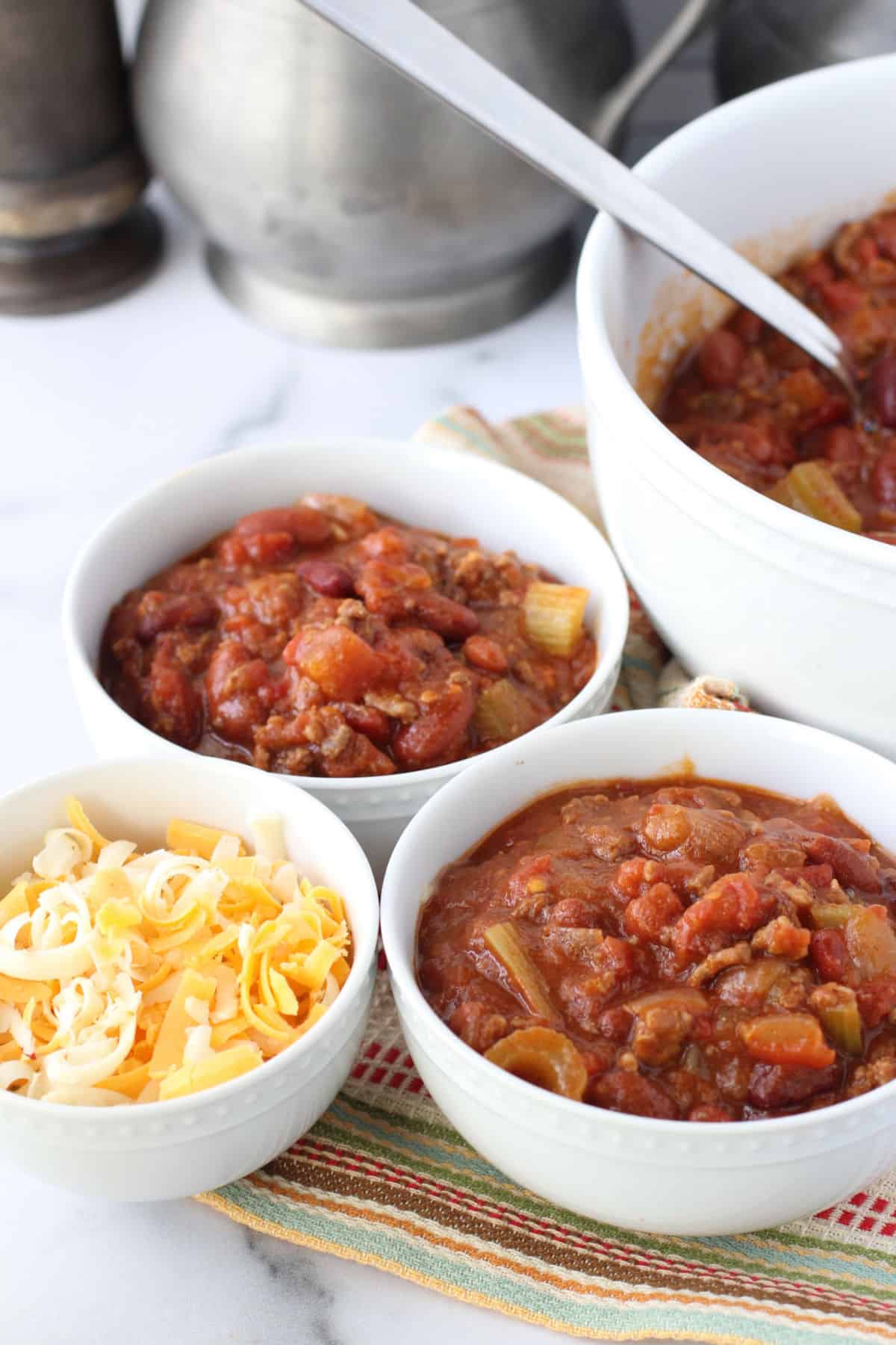 Chiliville Chili with a bowl of cheese.