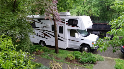 The RV in front on my mother's house in the rain. 