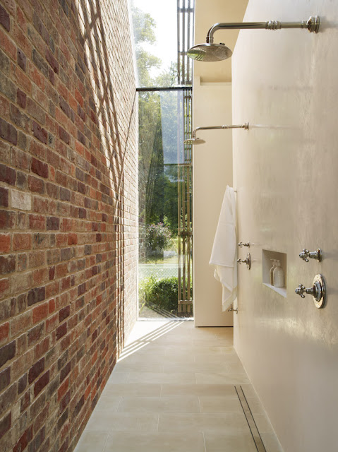 concrete and brick walkin shower with view to garden