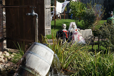 Outdoor Halloween decorating with skeletons - a bride and groom