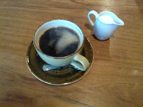A Harris and Hoole Long Black coffee with hot milk on the side