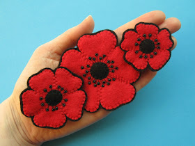 Three beaded felt poppy brooches