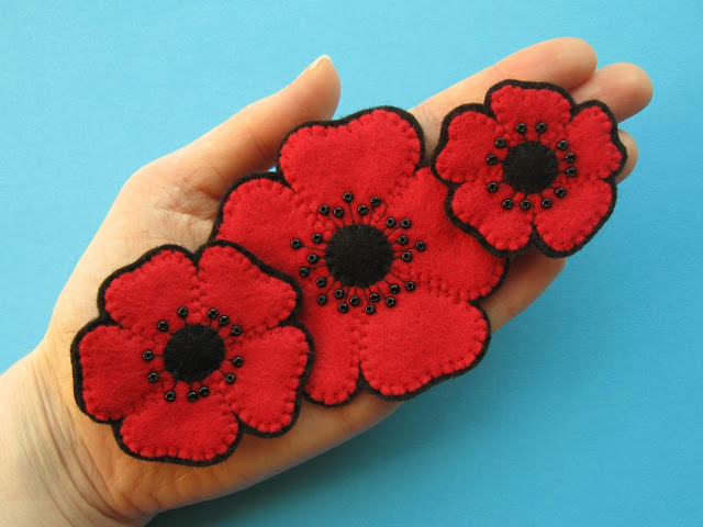 Three beaded felt poppy brooches