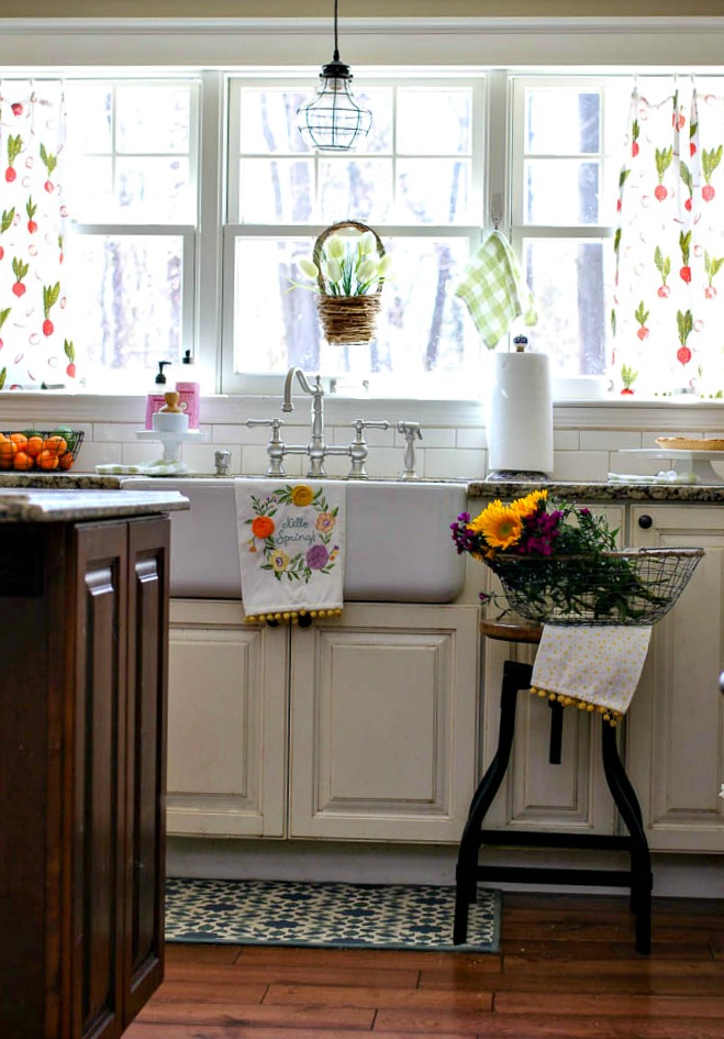 Lots of pops of color for spring in kitchen with farmhouse sink and flour sack curtains