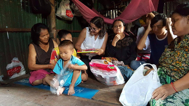 Norodom Ermine with people in the slum