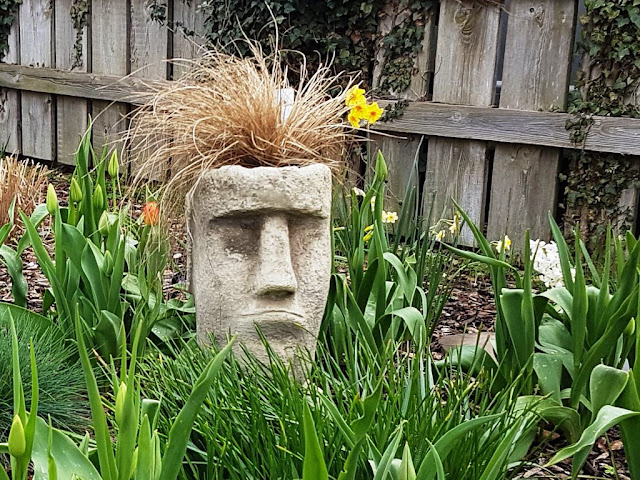 Miserable looking garden ornament with grass for hair