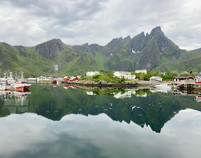 peaks reflected in water in Ballstad Norway