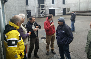 A small crowd gathers waiting for the shop to open