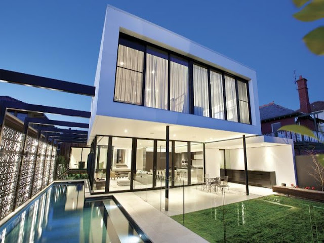 Photo of amazing modern home as seen at sunset from the pool area