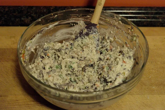 All of the ingredients in the mixing bowl have been mixed together to make the cheesy olive spread for the Cheesy Olive Bread Recipe.