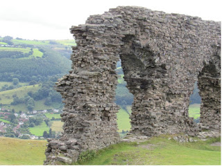 Stone arch overlooking green valleys