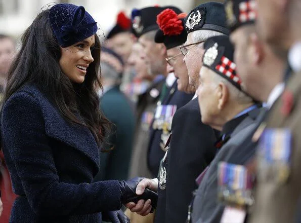 Meghan Markle wore Sentaler long wide collar wrap coat, Philip Treacy hat, Tamara Mellon boots. Royal British Legion traditional paper poppy