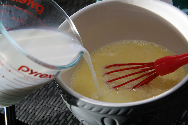 pouring milk into the egg mixture