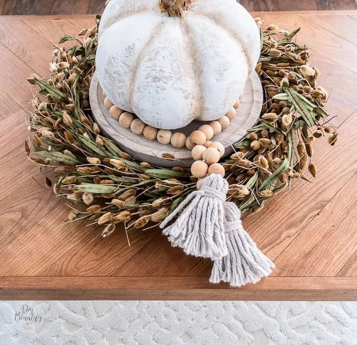 pumpkin centerpiece on herringbone coffee table