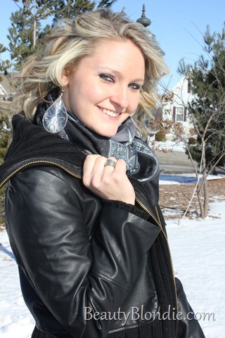 Black Leather Coat with Short Grey Boots, a Grey Scarf and Big Curly Hair