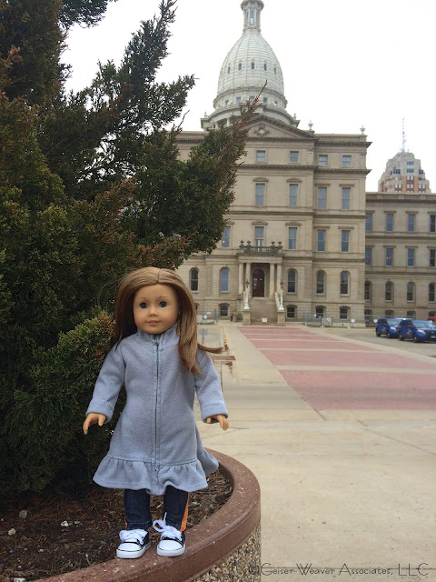 Bree visits Lansing with orange jeans-outfit by Geiser-Weaver Associates