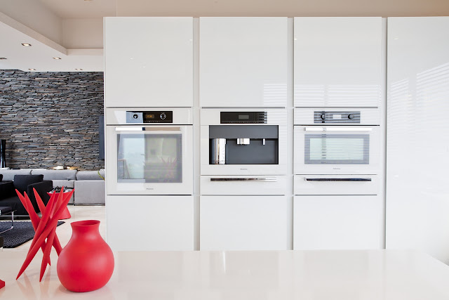 Picture of three elevated modern ovens in the kitchen