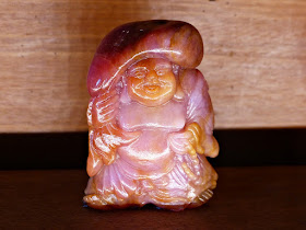 Happy Buddha sculpture carved from ruby 