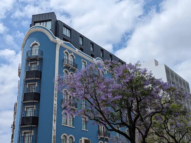 Blue building and purple jacaranda tree in Lisbon in May