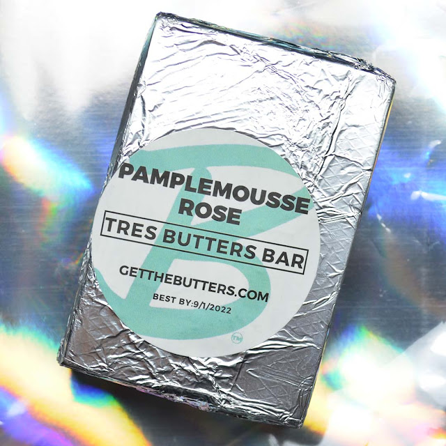 soap bar tightly wrapped in foil against holographic background