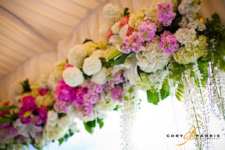 Deep pink peonies and deep purple kale leaves for this ceremony aisle