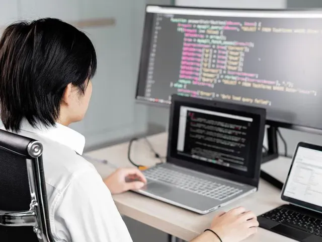 Image shows boy doing python coding