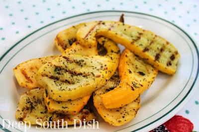 Thickly cut slices of summer squash, tossed with extra virgin olive oil, salt and pepper, and a mixture of dried herbs, then grilled.