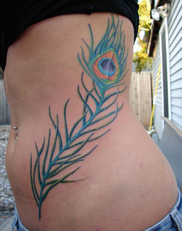 This is a very beautiful and stylish peacock feather tattoo design on the girl's side piece