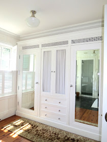 built in home closet with mirrors and drawers