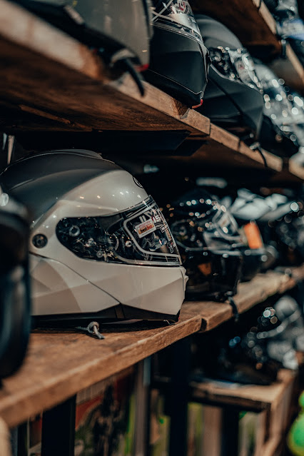 motorbike helmets on shelves:Photo by Gijs Coolen on Unsplash