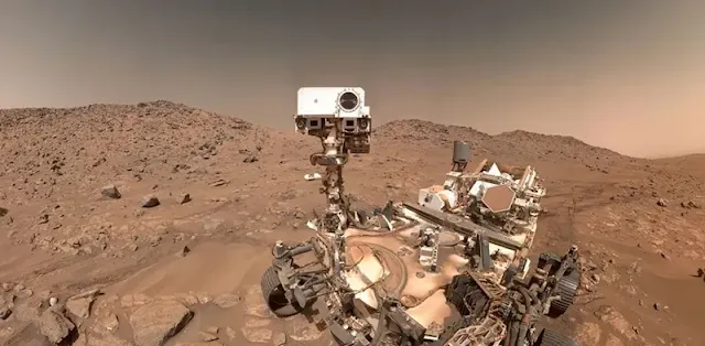 NASA’s Perseverance rover takes a selfie at Cheyava on Mars, showing its robotic arm extended with the Martian landscape in the background.