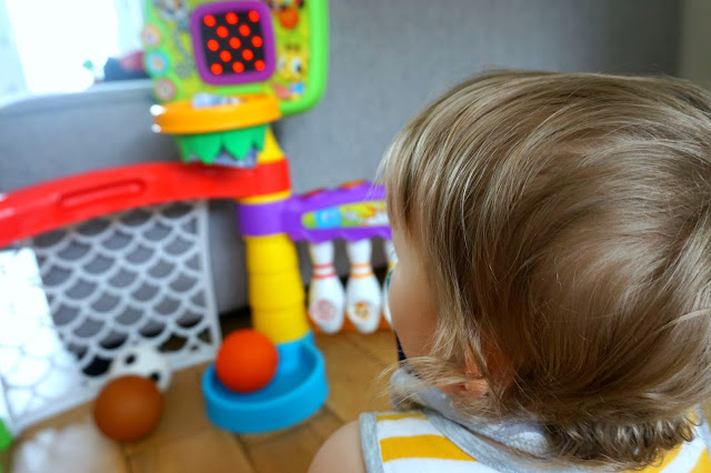 boy looking at little tikes light 'n' go 3-in-1 sports zone