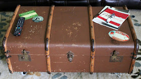 decoupage vintage luggage tags on an old trunk