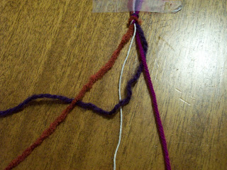 First strand of yarn woven across others.